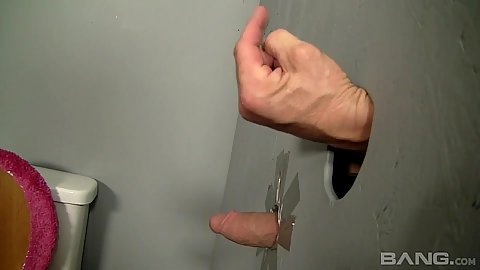 Charley Monroe looks at cock sticking out from glory hole