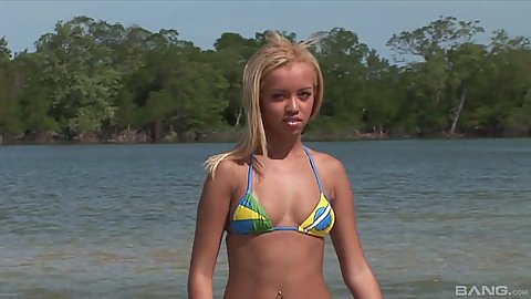 Barbie Banks is a sexy latina bikini girl jerking and sucking two dicks on the beach