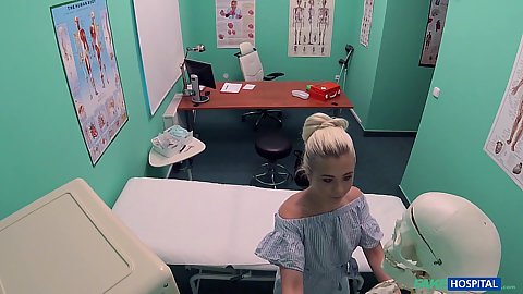 Clothed blonde youngster Anna Rey in the doctors office goes to get naked and wrap herself in a towel