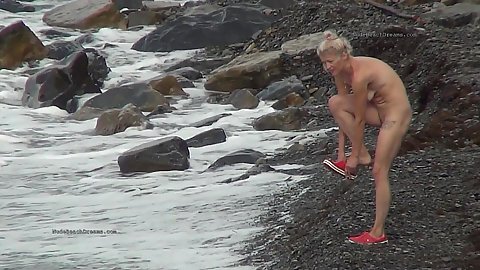 Blond euro amateur runs into the water on a nude beach unknowing of the fact that she is spied on by camera
