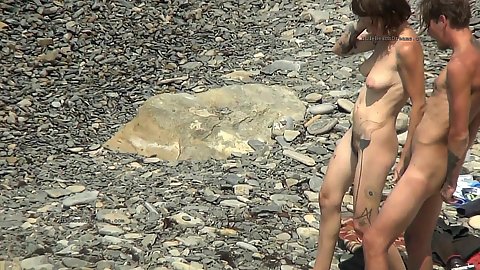 Naked small boobies wobblel quite nicely as this amateur brunette walks down the rocky beach