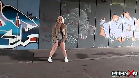 Girl tries to piss in public and flashing tits
