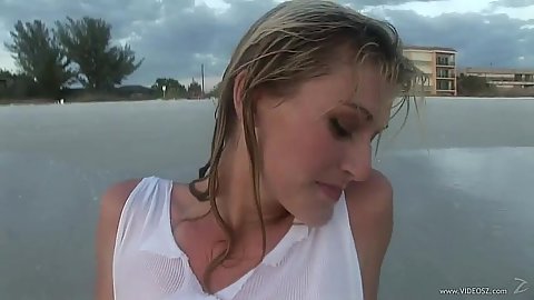 Amateur teen outdoor all wet in see through dress playing on the shore